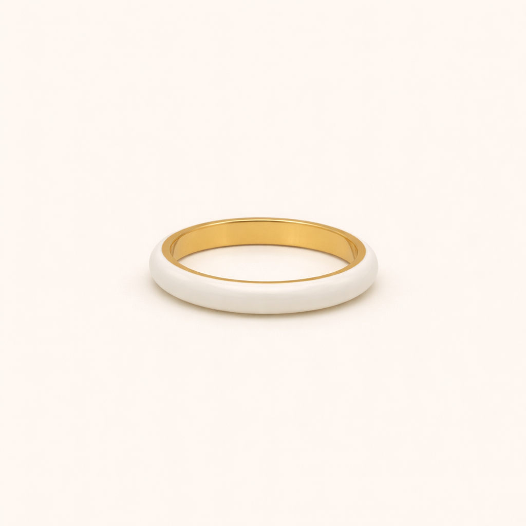 Gold and white ring on a beige background